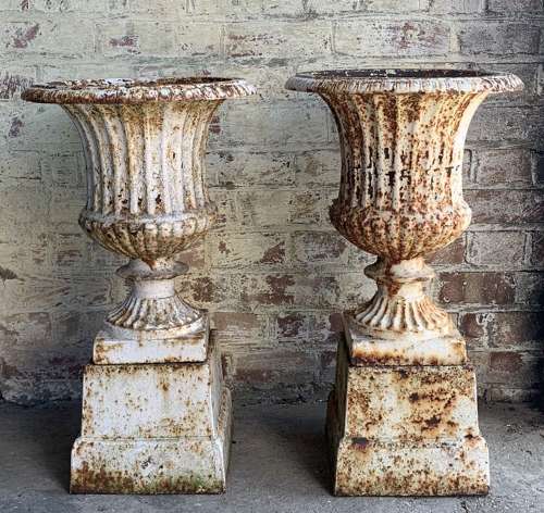 PAIR OF CAST IRON CAMPANA URNS